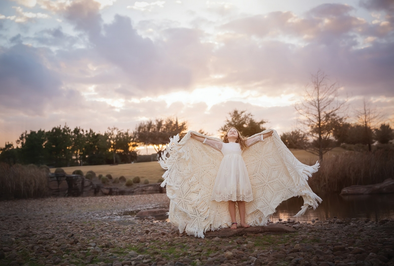 Chaddock doesn’t recommend spending much money on props—she’s been known to use leftover birthday party decorations for sessions. But one prop that’s worth its weight is a quilt. It can be a tablecloth, a tent, a blanket, a cape, a backdrop.