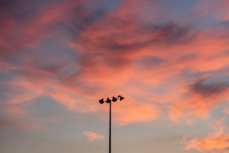 Photographed at f/2, this image shows the sharp light pole silhouetted against a dreamy bokeh sky. This due to a complex asymmetric optical design, which contributes to the heft and size of the lens.