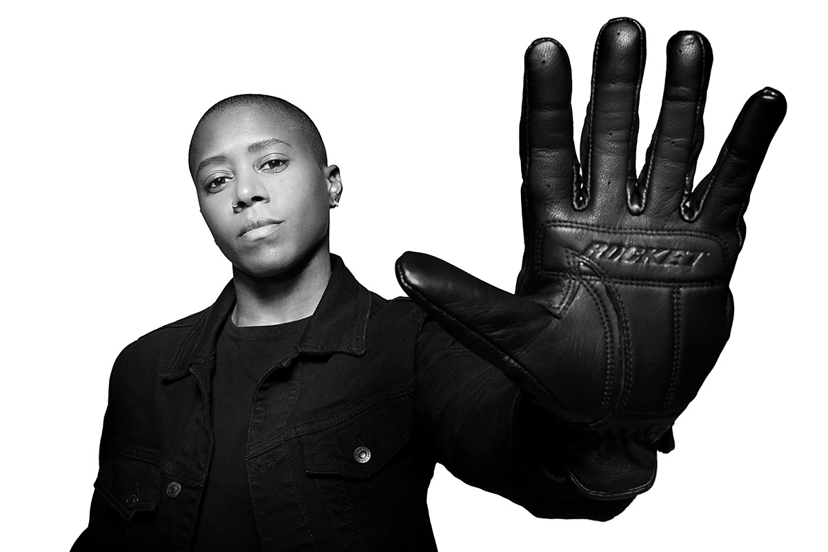 Black & white portrait of stuntwoman Cortni Vaughn Joyner, holding up her hand