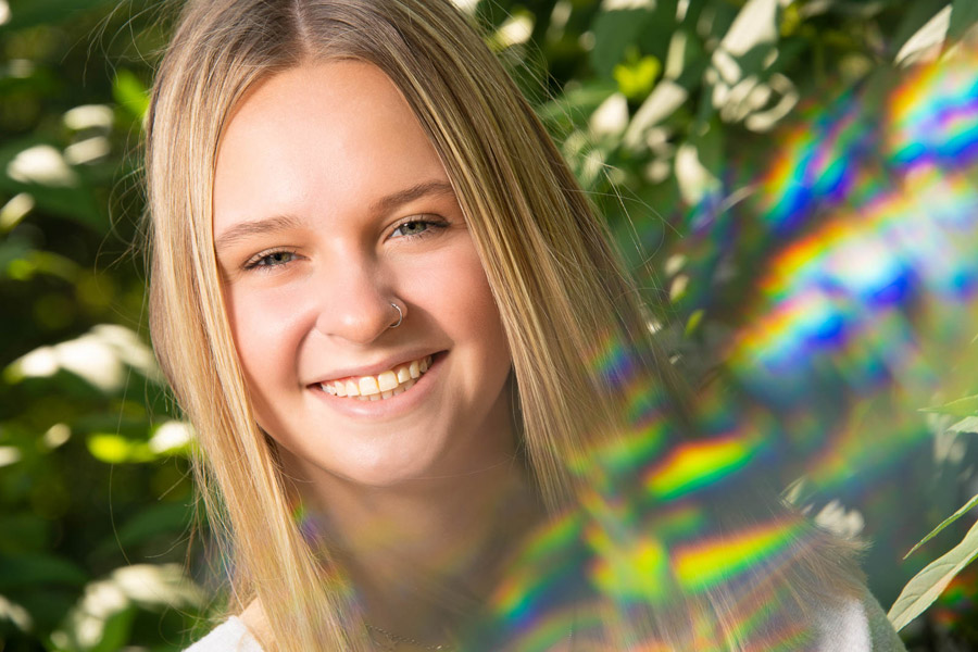 Portrait of a young person using Lensbaby Omni filters that create a blurred flare