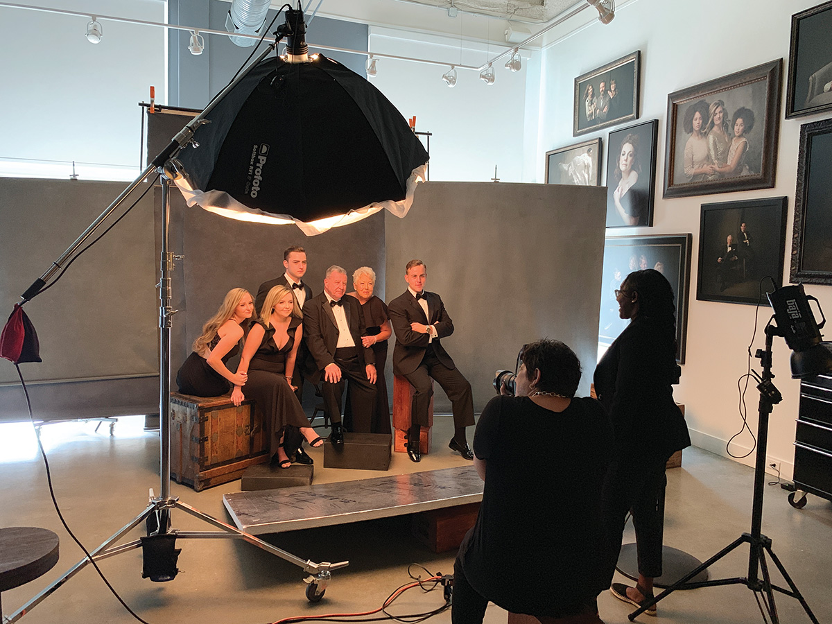 A family poses for a portrait at a photography studio