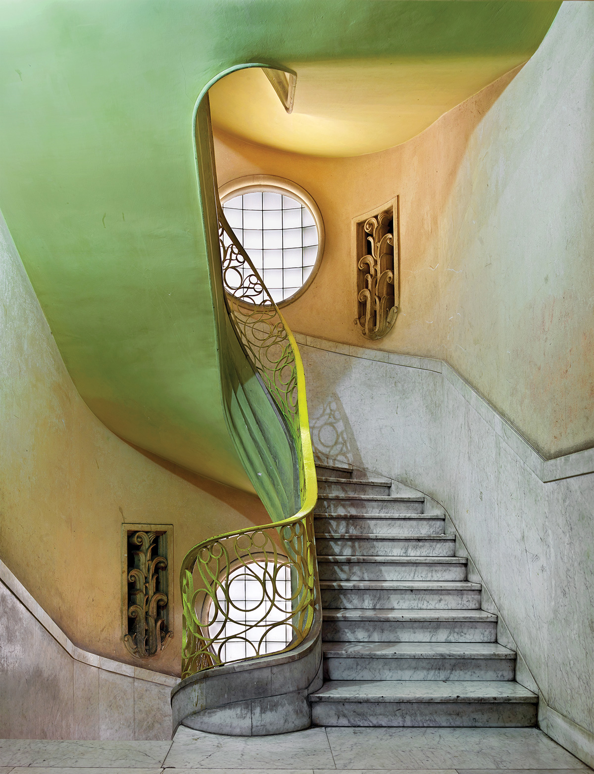 Curved stairwell with green ceiling