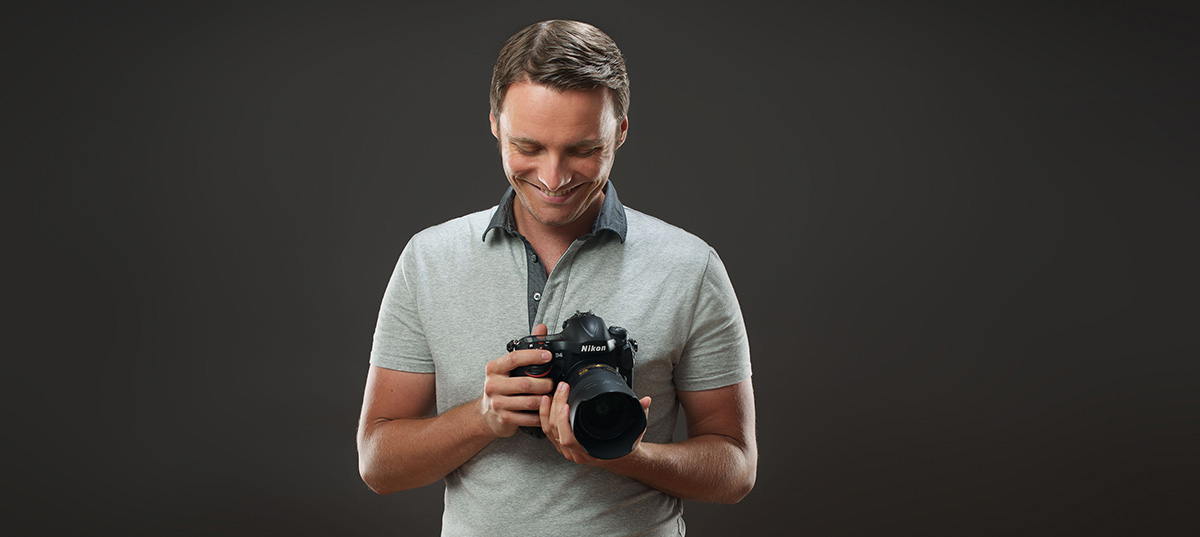 Michael Kormos holds a camera