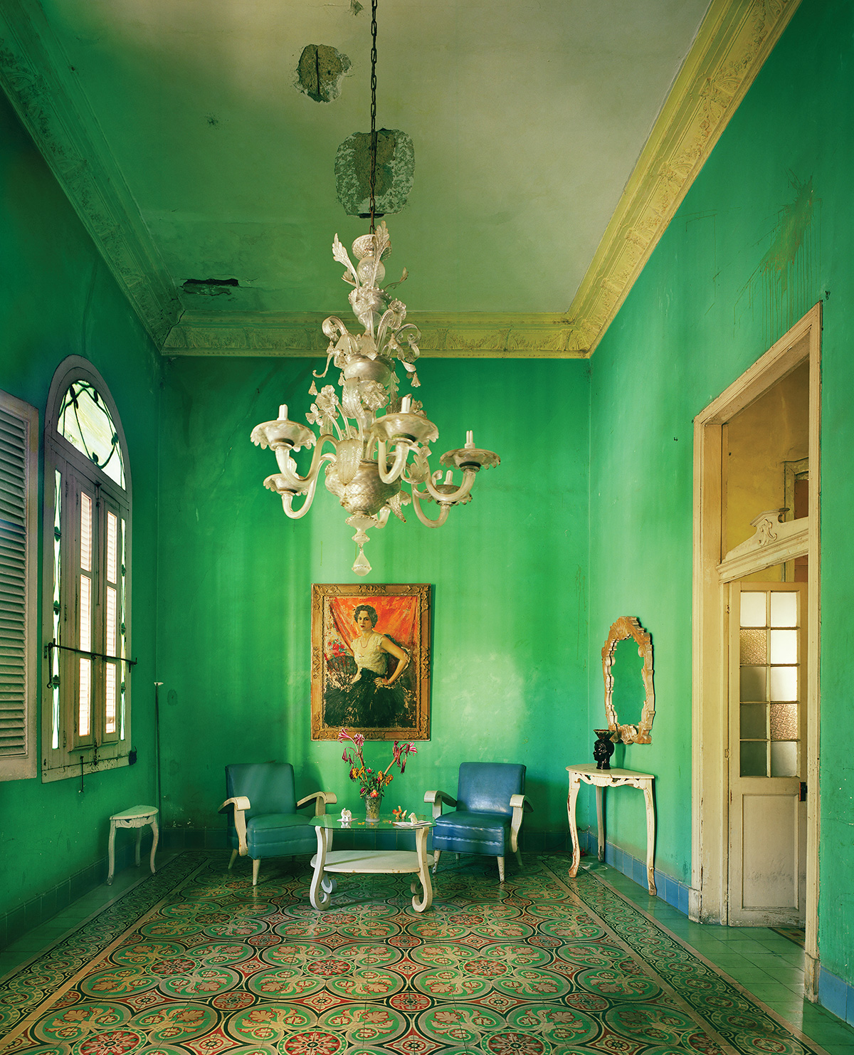 Room painted bright green with chandelier 