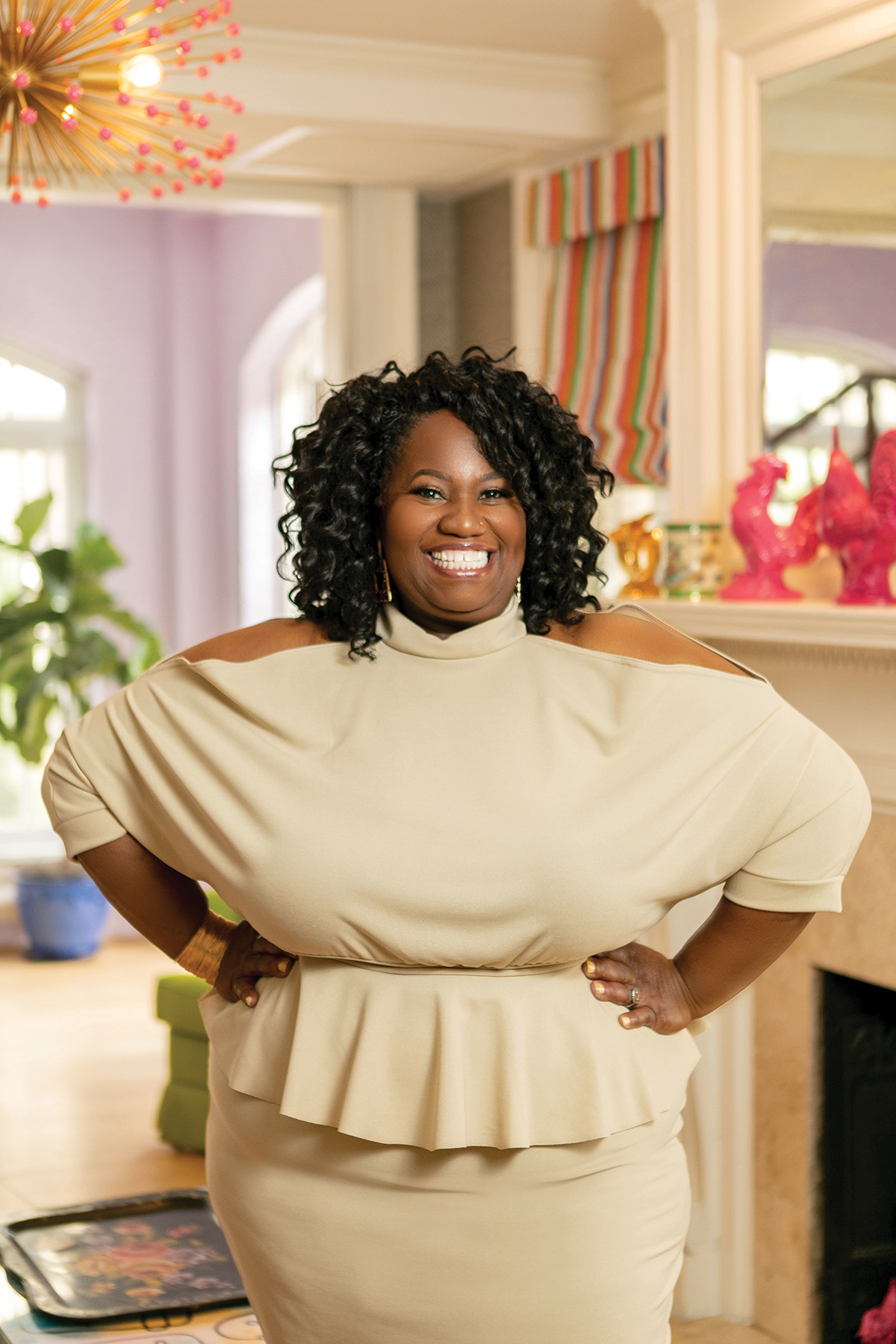 Portrait of business coach Shennice Cleckley, standing with hands on hips