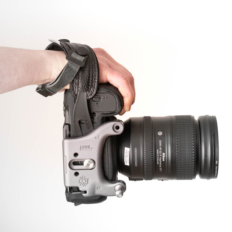 The SpiderPro Holster Single DSLR Camera System v2 includes several accessories, including a hand strap. 